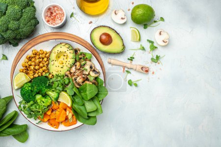 Photo for Healthy vegan lunch bowl with Avocado, mushrooms, broccoli, spinach, chickpeas, pumpkin on a light background. vegetables salad. Top view. - Royalty Free Image