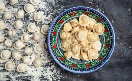 Photo for Traditional pelmeni, ravioli, dumplings with meat on a dark background. banner, menu, recipe place for text, top view - Royalty Free Image