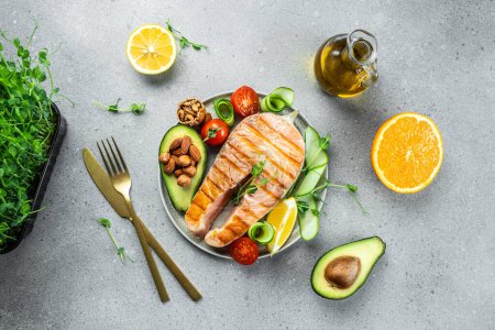 Photo for Grilled salmon steak with avocado and fresh vegetable salad. Keto diet, Healthy food concept. place for text, top view. - Royalty Free Image