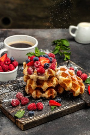 Téléchargez les photos : Berry Belgian Waffle with raspberries, strawberries and blueberries. Culinary, cooking, bakery concept. Food recipe background. Close up. - en image libre de droit