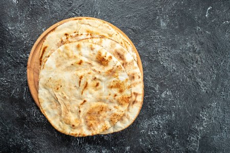 soft baked pita flatbreads, tortillas, bread. anner, menu, recipe place for text top view.