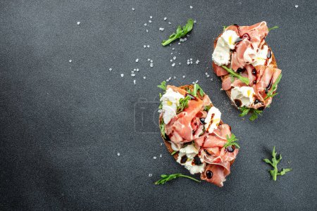 Photo for Delicious appetiser Italian prosciutto and Spanish Iberian ham snack. banner, menu, recipe place for text, top view. - Royalty Free Image