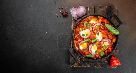 Frying pan with fresh shakshuka, Middle eastern traditional dish, Long banner format. top view,
