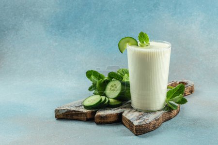 Ayran drink with mint and cucumber on a light background, organic healthy products. Detox and clean diet concept,
