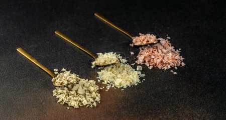 Photo for Collection of different types of salt on a dark background. Long banner format. top view. copy space for text. - Royalty Free Image