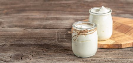 yogurt cream, natural homemade organic yogurt in a glass jar, lactose-free dairy products,
