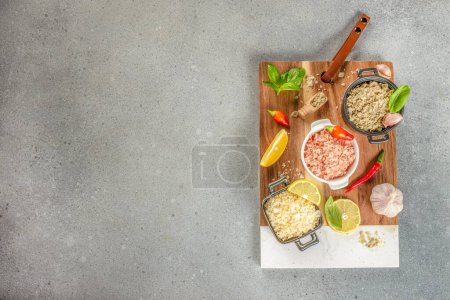 Different types of salt on a wooden board. banner, menu, recipe copy space, top view.