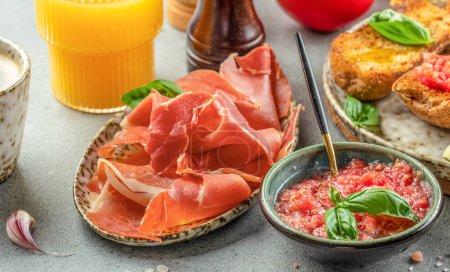 Toast with tomato and Olive oil and jamon ham, traditional Spanish breakfast.