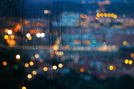 raindrops on the window and Bilbao city background 