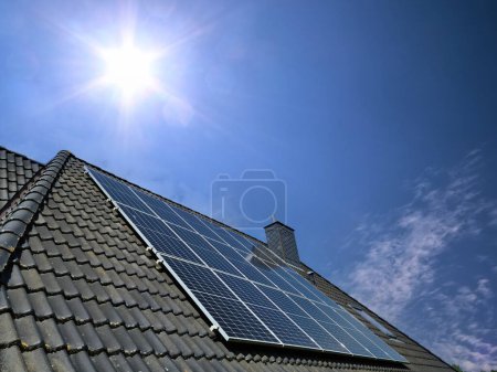 Photo for Solar panels producing clean energy on a roof of a residential house - Royalty Free Image