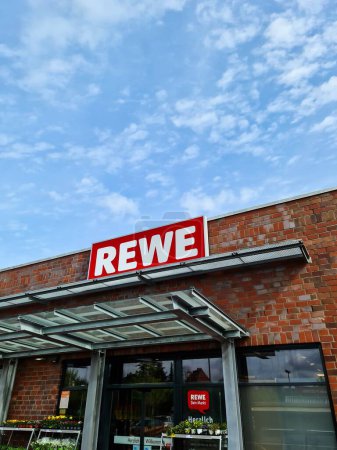Photo for Kiel, Germany - 04. May 2024: The logo of the discount chain REWE above the entrance to a supermarket branch - Royalty Free Image