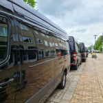 Neumuenster, Germany - 04. May 2024: Numerous black vans from Mercesdes Benz are parked in a row along a shopping street