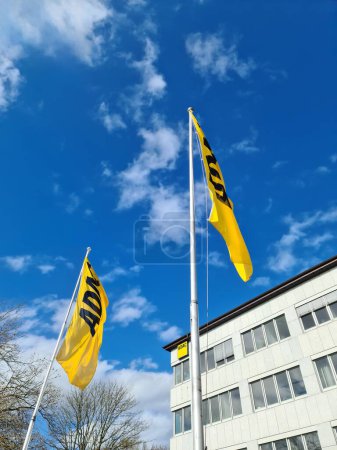 Photo for Kiel, Germany - 04. May 2024: The yellow flag of the German automobile club ADAC in front of a blue sky with a few clouds - Royalty Free Image