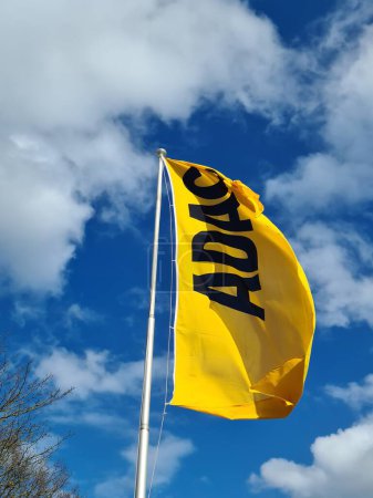 Photo for Kiel, Germany - 04. May 2024: The yellow flag of the German automobile club ADAC in front of a blue sky with a few clouds - Royalty Free Image
