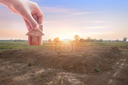 Photo for House symbol with location pin and Empty dry cracked swamp reclamation soil, land plot for housing construction project with and beautiful blue sky with fresh air Land for sales landscape concept - Royalty Free Image
