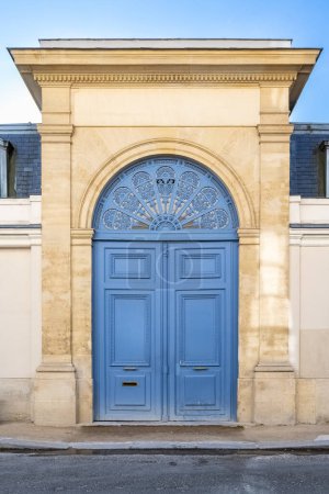 Paris, an ancient blue door, beautiful facade in a luxury neighborhood, rue Saint-Dominique, in the 7e arrondissement