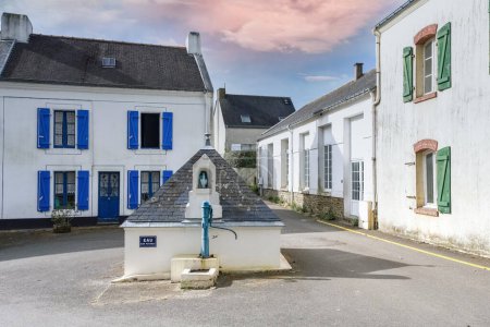 Bangor in Belle-Ile, Brittany, typical street in the village, a fountain in the center