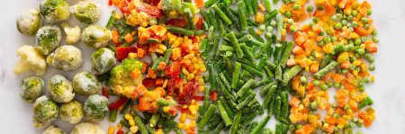 Photo for Frozen vegetable mix banner, frozen green beans and broccoli, corn and carrots, brussels sprouts and cauliflower, peas and bell peppers, copy space, top view - Royalty Free Image
