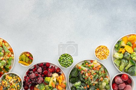 Photo for Preparing fresh vegetables in summer for winter, various frozen vegetables and berries in plates on a gray background, top view, copy space - Royalty Free Image