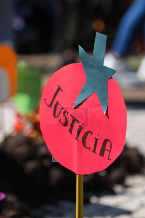 Photo for Buenos Aires, Argentina, Sept 21, 2021: detail of a protest of UTT, Land Workers Union, demanding the Land Access Law, defending agroecology and sustainable agriculture. Paper tomato with word justice - Royalty Free Image