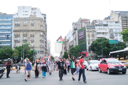 Foto de Buenos Aires, Argentina, 16 de febrero de 2024: Gente marchando por el centro con carteles pacifistas y banderas palestinas en solidaridad con Palestina y contra el ataque genocida de Israel. - Imagen libre de derechos