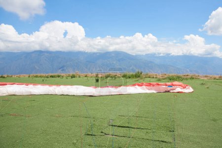 Paraglider wing extended on the ground, prior to a flight.Careful preparations are essential to minimize the risk in this type of extreme activities.