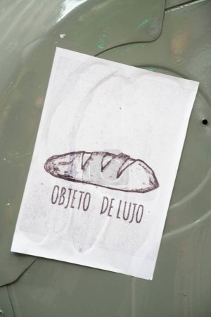 Photo for Buenos Aires, Argentina; March 8, 2024: poster reflecting the Argentine social and economic crisis: a loaf of bread with the text Luxury object - Royalty Free Image