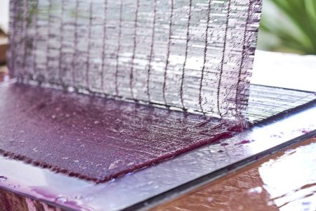 Photo for Process of making a purple sheet of handmade paper made with natural fibers and dyes. - Royalty Free Image