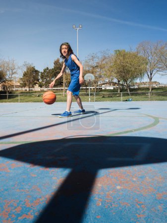 Photo for Young basketball player in the shadow of the basket. - Royalty Free Image