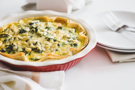 Photo for Quiche. Healthy homemade chicken pie with broccoli and spinach on white wooden table - Royalty Free Image