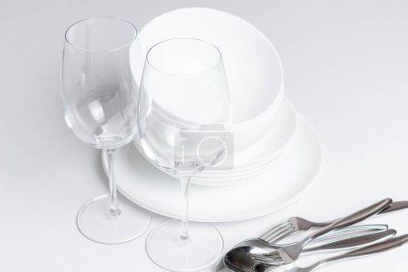 Photo for Empty glasses with cutlery on white background - Royalty Free Image