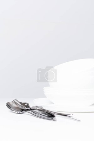 Photo for Empty white dishes on a white background - Royalty Free Image