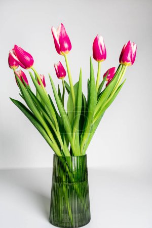 Photo for Bouquet of pink tulips in glass vase - Royalty Free Image