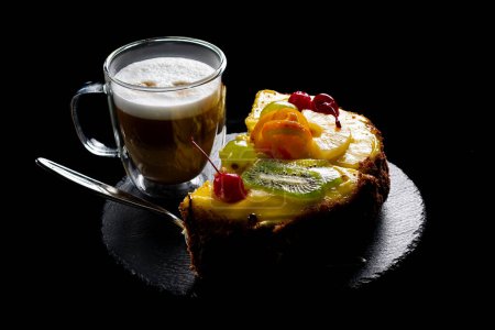 Photo for Latte in glass cup with cake served on a black background. - Royalty Free Image