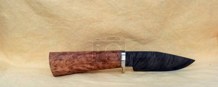 A beautiful fixed blade hand made knife featuring a gorgeous damascus blade and lovely wooden handle. The knife is both pretty and functional.