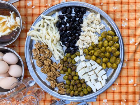 Photo for Platter of olives, cheese, walnuts prepared for breakfast in Turkey - Royalty Free Image