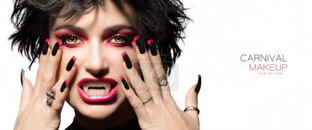 Foto de Carnival Beauty and Makeup Concept. High fashion portrait. Sexy vampire woman with gothic make up, georgeous smoky eyes in red to match lipstick and manicured nails with black and red nail art design. - Imagen libre de derechos