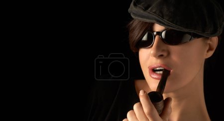 Foto de Beauty smoking an electronic pipe. Studio portrait isolated on black with copy space - Imagen libre de derechos