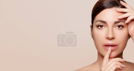 Photo for Beauty and Skin Care Concept. Beautiful natural woman with clean healthy luminous skin. Panorama banner with lateral beige copy space. - Royalty Free Image