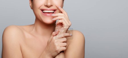 Photo for Beautiful woman with smiling expression. Skin Care, Spa and Beauty Concept. Studio cropped portrait on grey background with copy space - Royalty Free Image