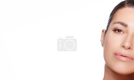 Photo for Beauty and Skincare concept. Beautiful model girl face with nude makeup on a flawless skin looking at camera with a serene expression. Closeup portrait isolated on white - Royalty Free Image
