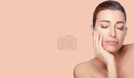 Photo for Beauty and Skincare Concept. Beautiful natural young woman face with a healthy flawless skin on a split panorama with lateral white copyspace. - Royalty Free Image