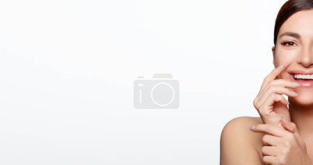Photo for Glowing Complexion. Portrait of a Latin woman with a bright smile and flawless skin, showcasing the results of her skincare routine. The white background adds a soothing atmosphere to the image, highlighting her natural beauty - Royalty Free Image