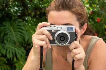 Photo for A woman taking pictures. Girl with a photo camera outdoors. Traveling and photographing concept. Panorama banner with copy space - Royalty Free Image