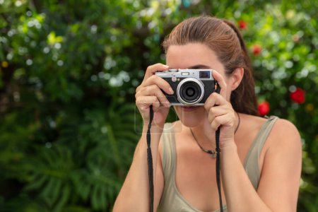 Photo for Pretty woman taking pictures outdoors. Close-up portrait with copy space - Royalty Free Image