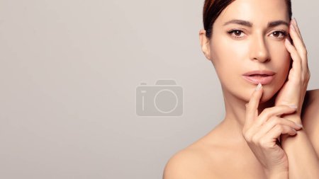 Photo for Confident young adult with glowing, moisturized skin. Peaceful headshot showcasing natural beauty and rejuvenation. Copy space for cosmetics. - Royalty Free Image