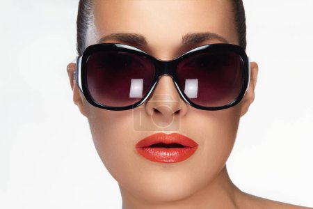 Close-up of a fashionable woman wearing oversized sunglasses, showcasing beauty and high fashion eyewear. Perfect for beauty and fashion campaigns. Isolated on white.