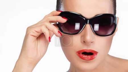Fashion close-up of a beautiful woman wearing stylish sunglasses, isolated on a white background, showcasing modern eyewear and beauty.