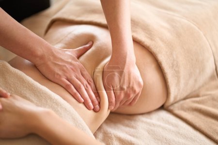 A woman receiving a belly massage at a beauty salon