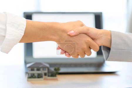 Photo for A man and a woman shaking hands during a real estate contract - Royalty Free Image